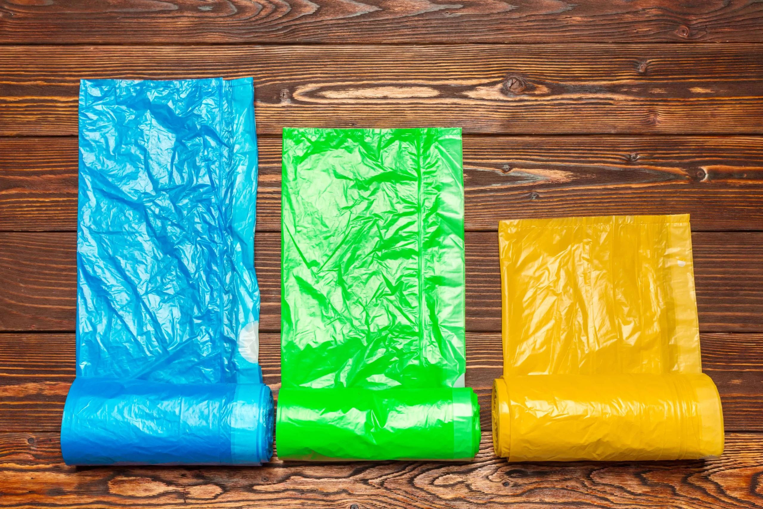 different plastic bags on wooden background